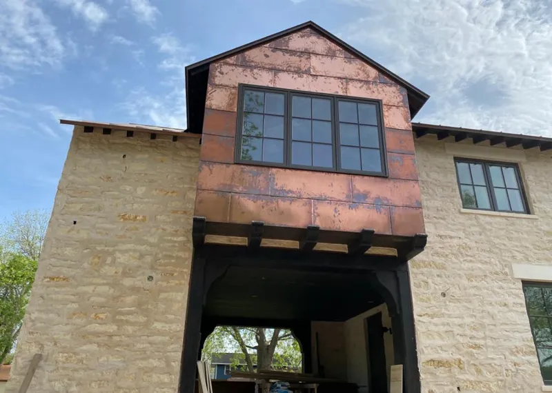 Copper metal panel facade on a stone building for Skylight Installation in Laurinburg
